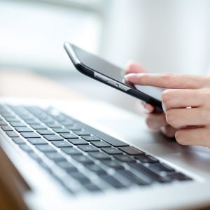 Young woman using a mobile phone and laptop Young woman using a mobile phone and laptop
